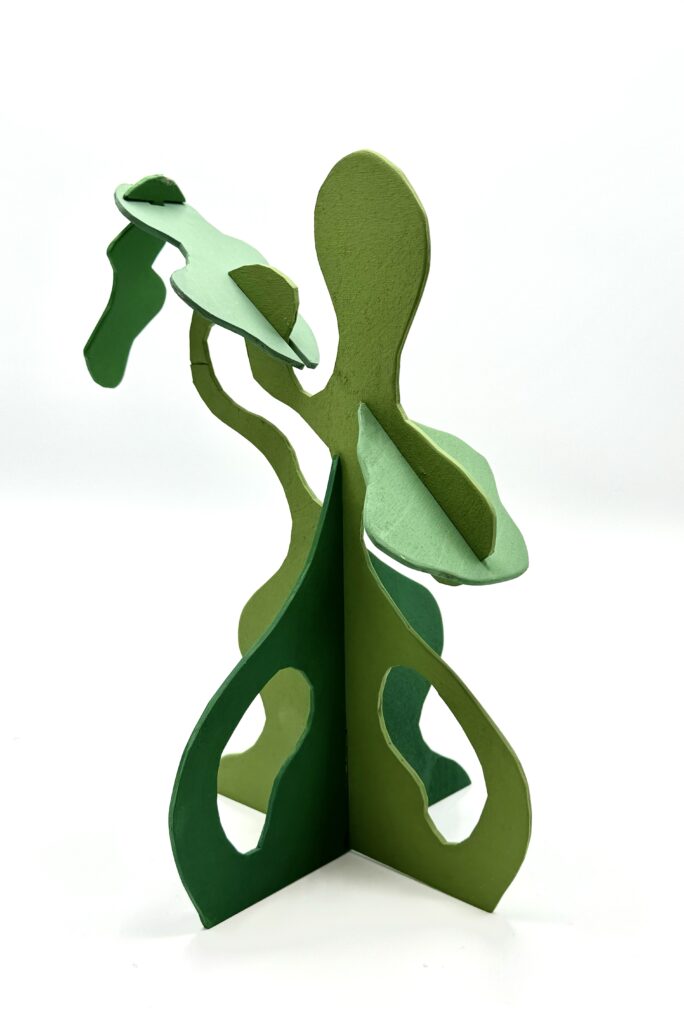Green wooden sculpture made of up interlocking, wavy-shaped pieces.