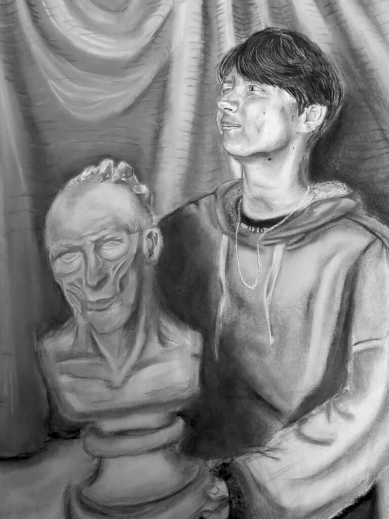 Charcoal drawing of a young person in front of drapery with their hand on a sculpture of an old man.